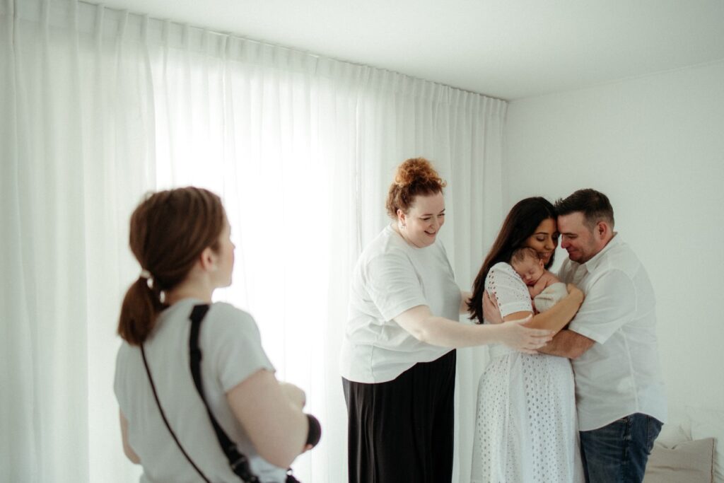 family being photographed by two photographers - Attract Your Dream Clients