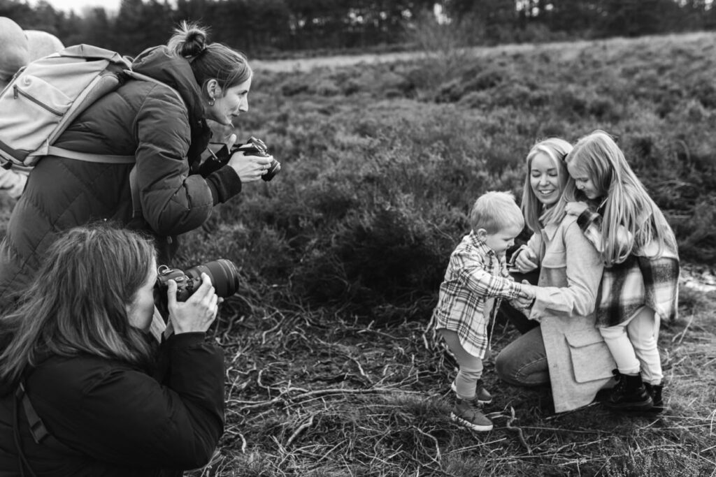 behind the scenes of a family session with two photographers and a family of four - Attract Your Dream Clients